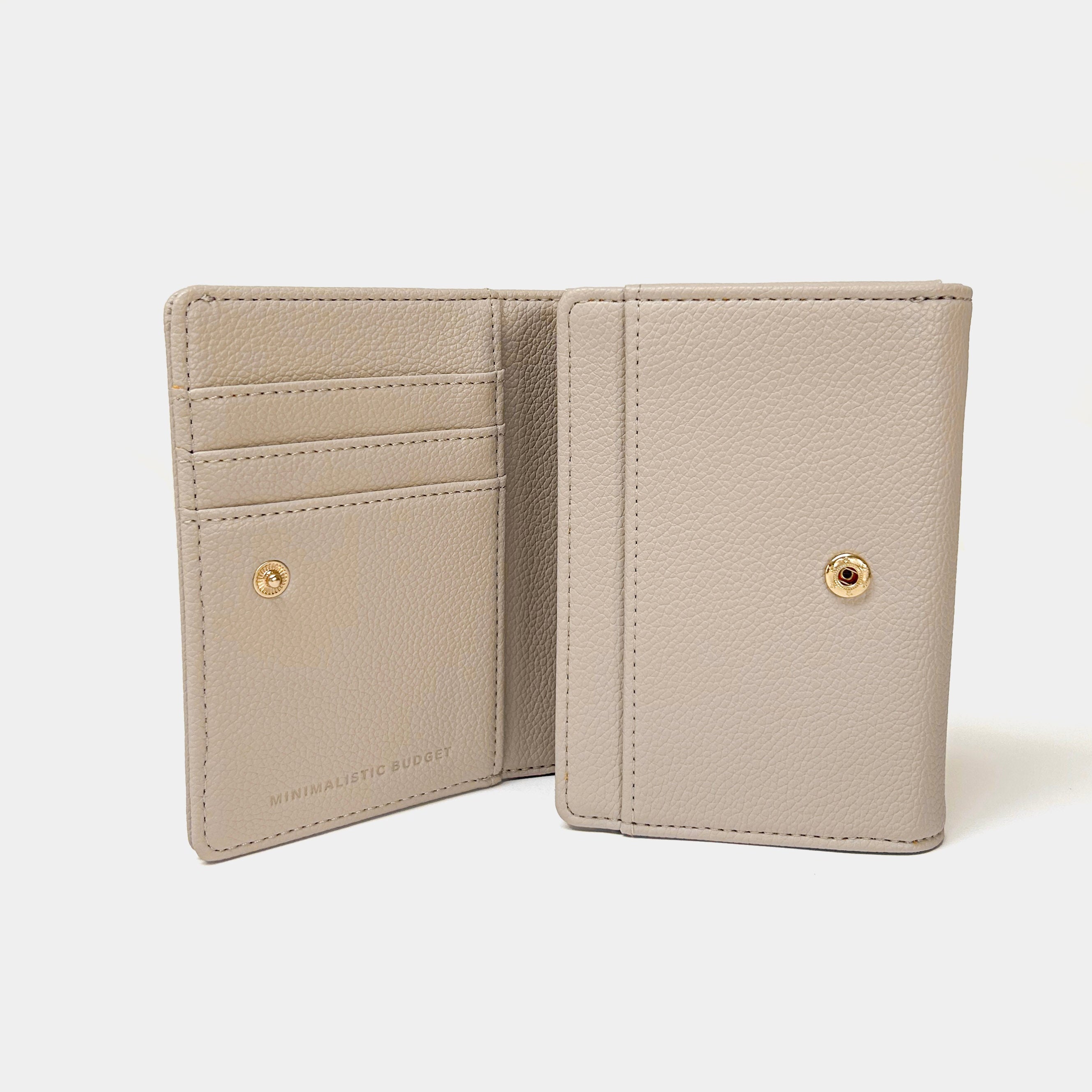 Beige wallet with gold accents on a white background