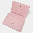 Pink wallet with gold accents on a light gray background