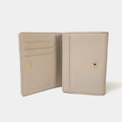 Beige wallet with gold accents on a white background