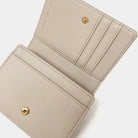 Beige wallet with gold accents on a white background