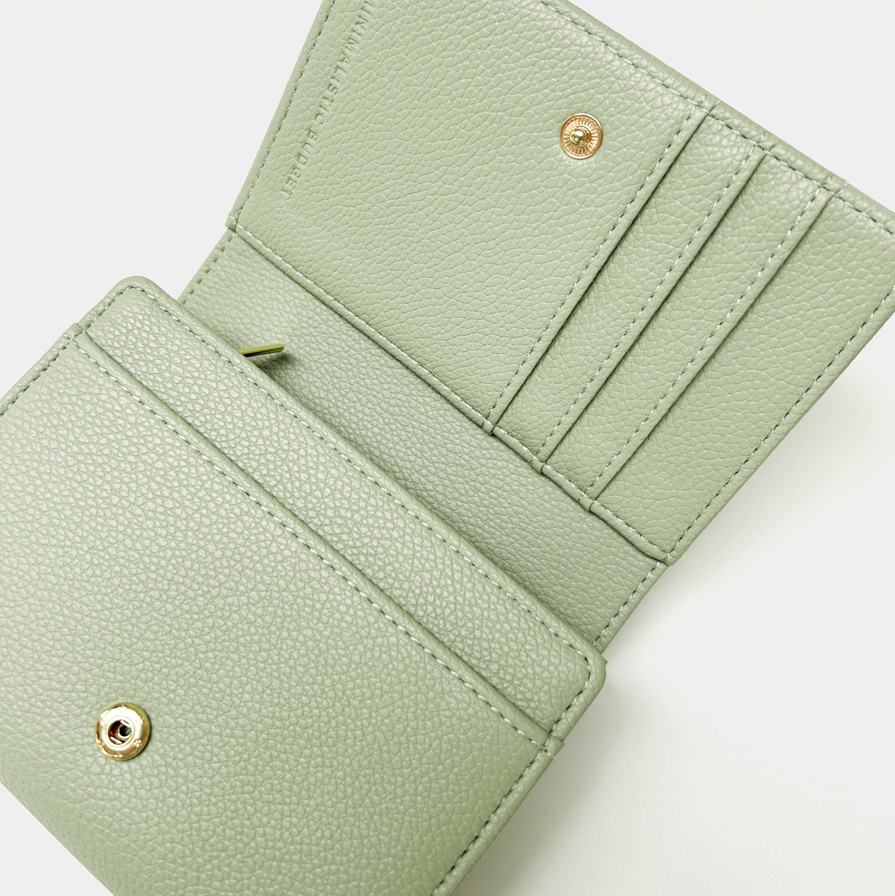 Green wallet with gold accents on a white background